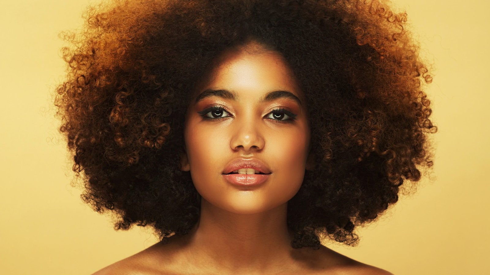 Studio portrait of young beautiful african girl with black afro hair